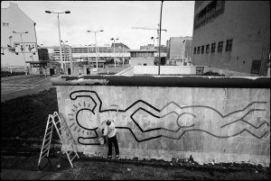 Keith Haring, american artist, makes painting on the Berlin Wall. Berlin, 1986.